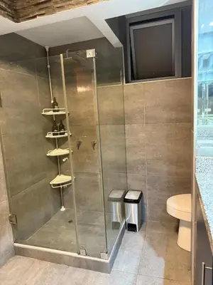 a shower with a glass door in a bathroom at Welcoming apartment in Lima