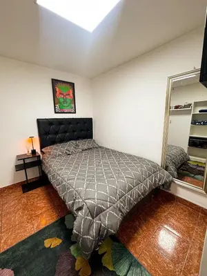 a bedroom with a bed in the corner of a room at Miraflores, baño privado, ingreso independiente in Lima