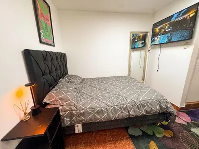 a bedroom with a bed in a room with a table at Miraflores, baño privado, ingreso independiente in Lima