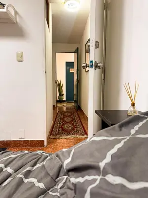 a bedroom with a bed and a hallway at Miraflores, baño privado, ingreso independiente in Lima