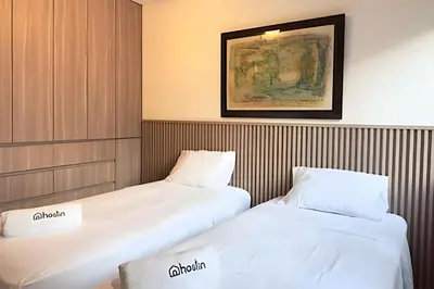 two beds sitting next to each other in a room at The 28 Residence Miraflores in Lima