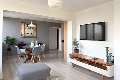 a living room with a table and a dining room at The 28 Residence Miraflores in Lima