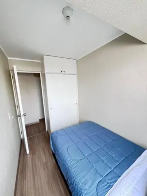 a bedroom with a blue bed and white cabinets at La Foret in Lima