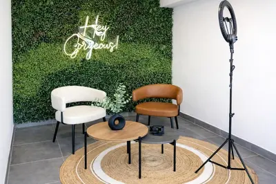 a group of chairs in a room with a green wall at La Foret in Lima