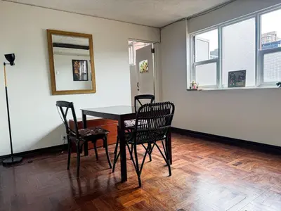 a dining room with a table and chairs at Miraflores, habitación en apartamento compartido in Lima