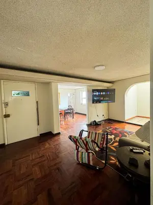 a living room with a couch and a table at Miraflores, habitación Triple en apartamento compartido in Lima