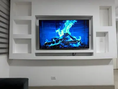 a tv with a fire in a living room at Apartamento moderno a 5 minutos de Plaza Norte in Lima