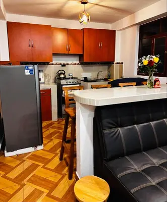 a kitchen with a island in the middle of it at Tampumachay in Cusco