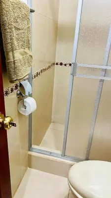 a bathroom with a shower with a toilet and a sink at Tampumachay in Cusco