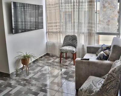 a living room with a couch and a chair at Lindo depa cerca a huacachina in Ica