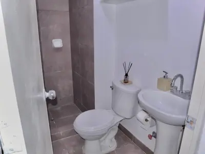 a bathroom with a toilet and a sink at Lindo depa cerca a huacachina in Ica