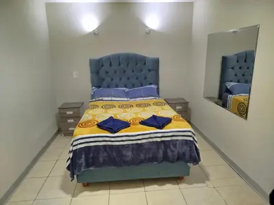 a bedroom with a blue bed with two blue pillows at Hostal San Ignacio Monterrico in Lima