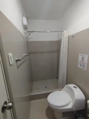 a bathroom with a toilet and a shower at Hostal San Ignacio Monterrico in Lima