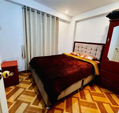a bedroom with a bed and a window at Tampumachay in Cusco