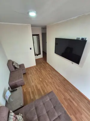 a living room with a couch and a flat screen tv at Luna Room in Lima