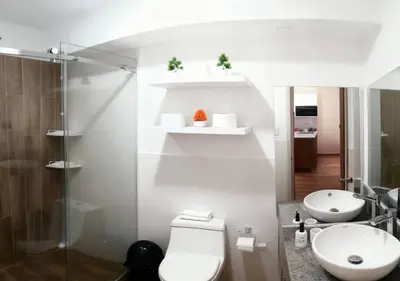 a bathroom with a toilet and a sink at E 24h Urban Comfort 1BR 302 in Lima