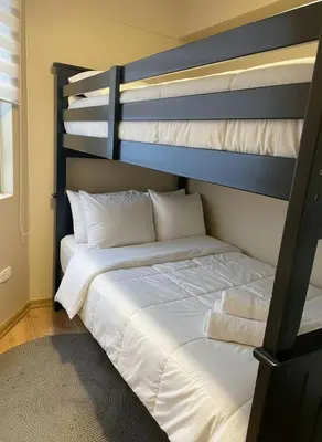 a bedroom with a bunk bed with white sheets and pillows at E Magdalena Costanera Access Wifi Pro 2B 204 in Lima