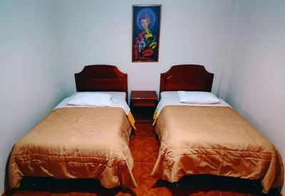 a room with two beds in a room at Inkas Hotel Cusco in Cusco
