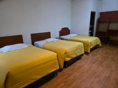 two beds with yellow covers in a room at Inkas Hotel Cusco in Cusco