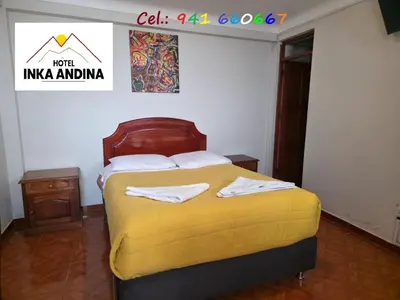 a bedroom with a bed with a yellow blanket at Inkas Hotel Cusco in Cusco
