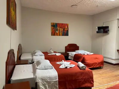 a hospital room with three beds and a tv at Inkas Hotel Cusco in Cusco