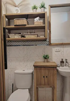 a bathroom with a toilet and a sink and a mirror at C&S Apartment Fierro in Cusco