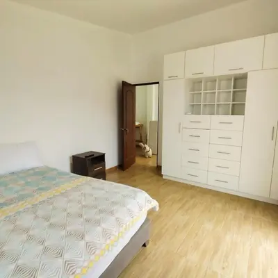 a bedroom with a bed and white cabinets at Casa de Campo Privada en Cieneguilla con Piscina y Cine in Cieneguilla
