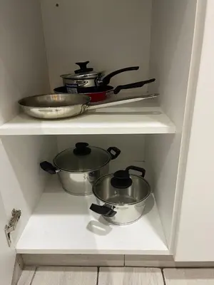 two pots and pans on a shelf in a kitchen at Penthouse con Vista al Mar in Lima