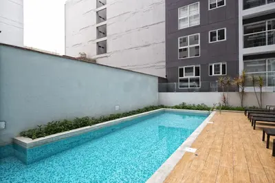 a swimming pool on the side of a building at Upper Pardo Apartments in Lima
