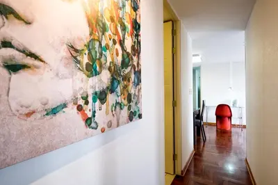 a painting hanging on a wall in a hallway at Guernica Apartments in Lima