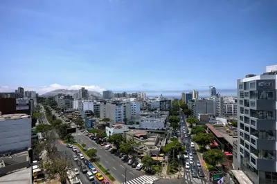 an aerial view of a city with traffic at Guernica Apartments in Lima