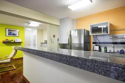 a kitchen with a large counter with a refrigerator at La Masia Apartments in Lima