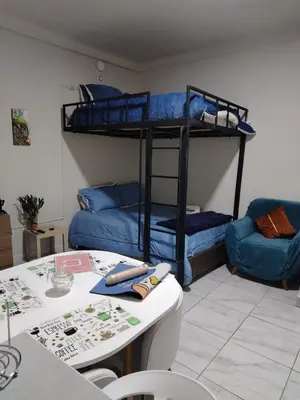 a room with two bunk beds and a table at loft Inti in Cusco
