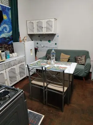 a living room with a table and a green couch at loft Inti in Cusco