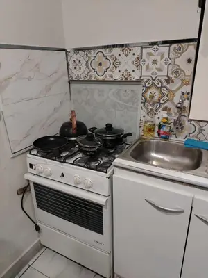 a kitchen with a white stove and a sink at loft Inti in Cusco
