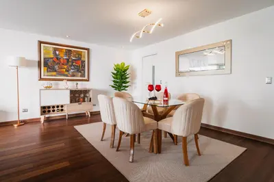 a dining room with a table and chairs at Espectacular vista al mar en Miraflores in Lima
