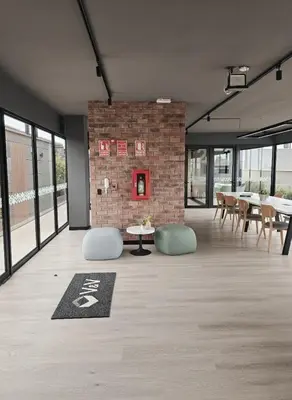 a room with tables and chairs and a brick wall at Apartment suite in the heart of Miraflores! in Lima