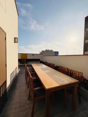 a long table on the roof of a building with chairs at Departamento AltoVerde - Pueblo Libre in Lima