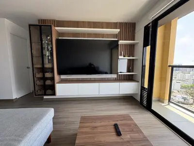 a living room with a large flat screen tv at Cozy bedroom in Miraflores with rooftop pool in Lima