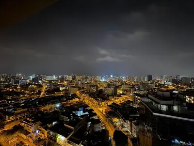 a view of a city at night at Cozy bedroom in Miraflores with rooftop pool in Lima