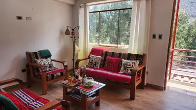 a living room with two chairs and a couch at Chakana Wasi in Calca