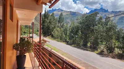 a balcony with a view of a road and mountains at Chakana Wasi in Calca
