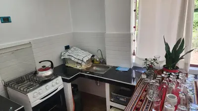 a small kitchen with a stove and a sink at Chakana Wasi in Calca