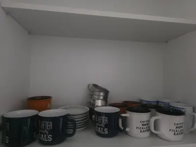 a bunch of coffee mugs sitting on a shelf at Departamento equipado, cómodo, tranquilo y céntrico in Lima
