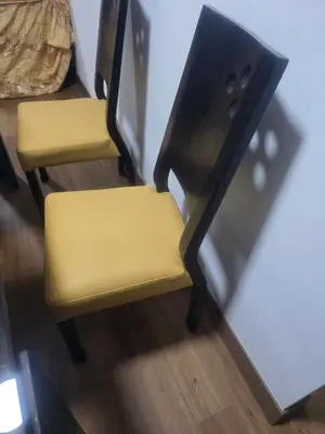 two chairs with yellow seats next to a wall at Departamento equipado, cómodo, tranquilo y céntrico in Lima