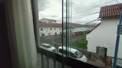 a window with a view of a car on a street at Maruri Valentino apartment in Cusco