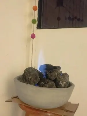 a bowl of rocks sitting on top of a table at Maruri Valentino apartment in Cusco