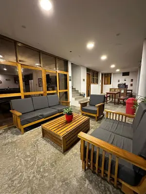 a living room with couches and chairs and tables at La Fogata del Sur in Asia