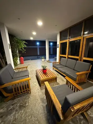 a patio with couches and tables on a building at La Fogata del Sur in Asia