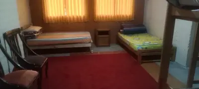 a small room with two beds and a red rug at Cozy Rural House in Apata - Jauja